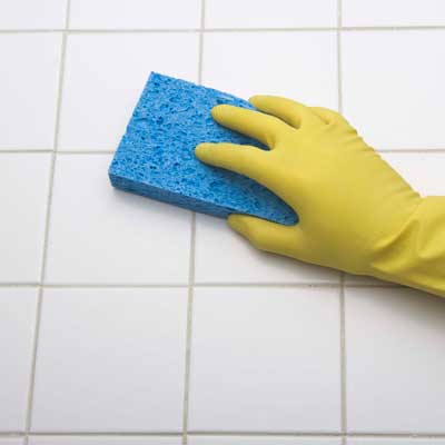 cleaning tile with a sponge