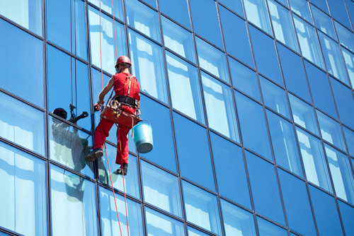 Person Cleaning High Windows title=
