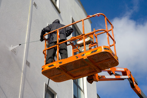 Person Power Washing Wall title=