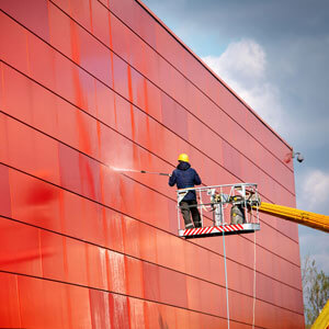 man pressure washing side of building man pressure washing side of building