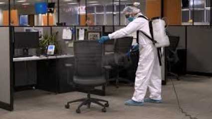 Biohazrd worker cleaning office