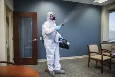 Person in biohazard suit cleaning office